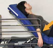 Broken arm caused by lifting the back while the arm is caught in the rail.